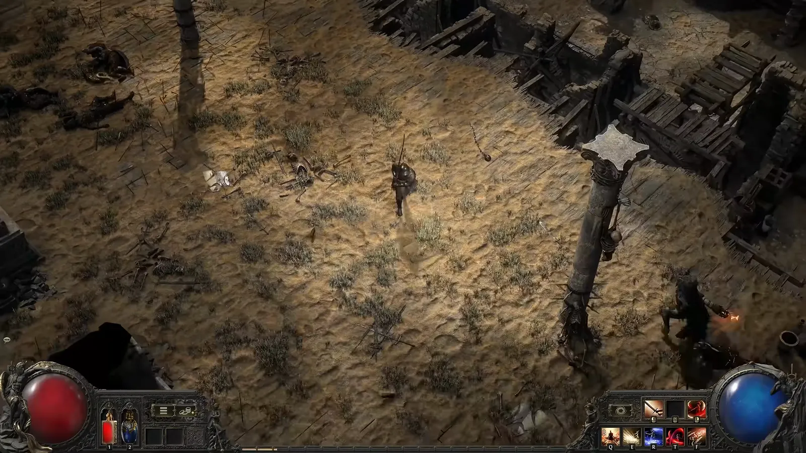 Overhead view of the Duelist standing on sand among Grand Arena ruins, wooden debris, and fallen fighters in Path of Exile 2